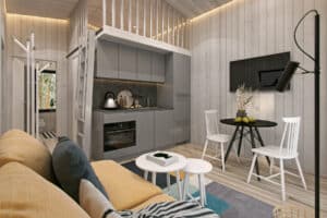 grått kök och vardagsrum med gul soffa i välinrett attefallshus 30 kvm